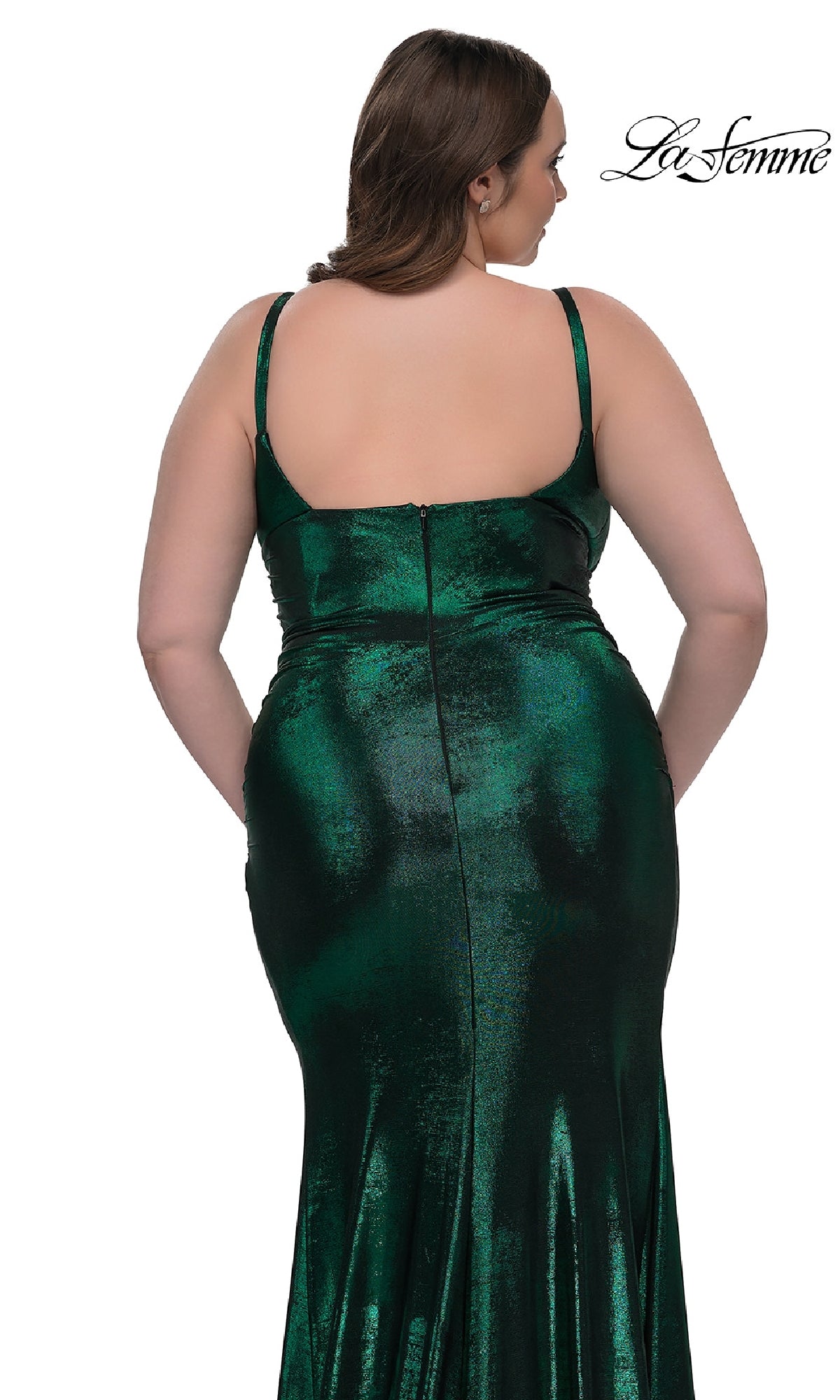 A woman with long brown hair models the Plus-Size Long Metallic Prom Dress: La Femme 33020, featuring thin straps and a shimmering finish, shown from the back against a white background with the La Femme logo.